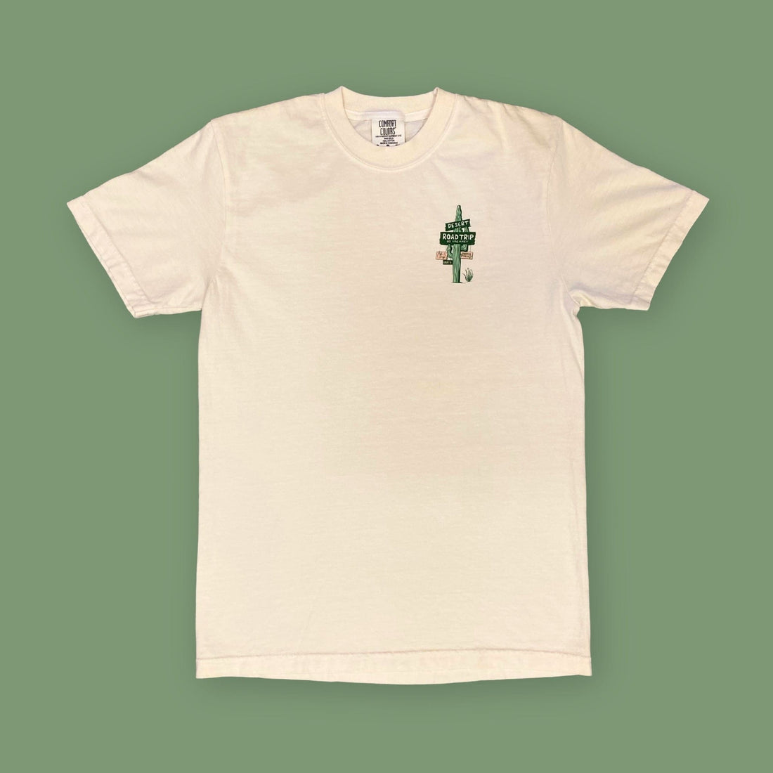 Opal Atlas desert road trip T-shirt in cream, shown flat with a small cactus sign graphic on the front.