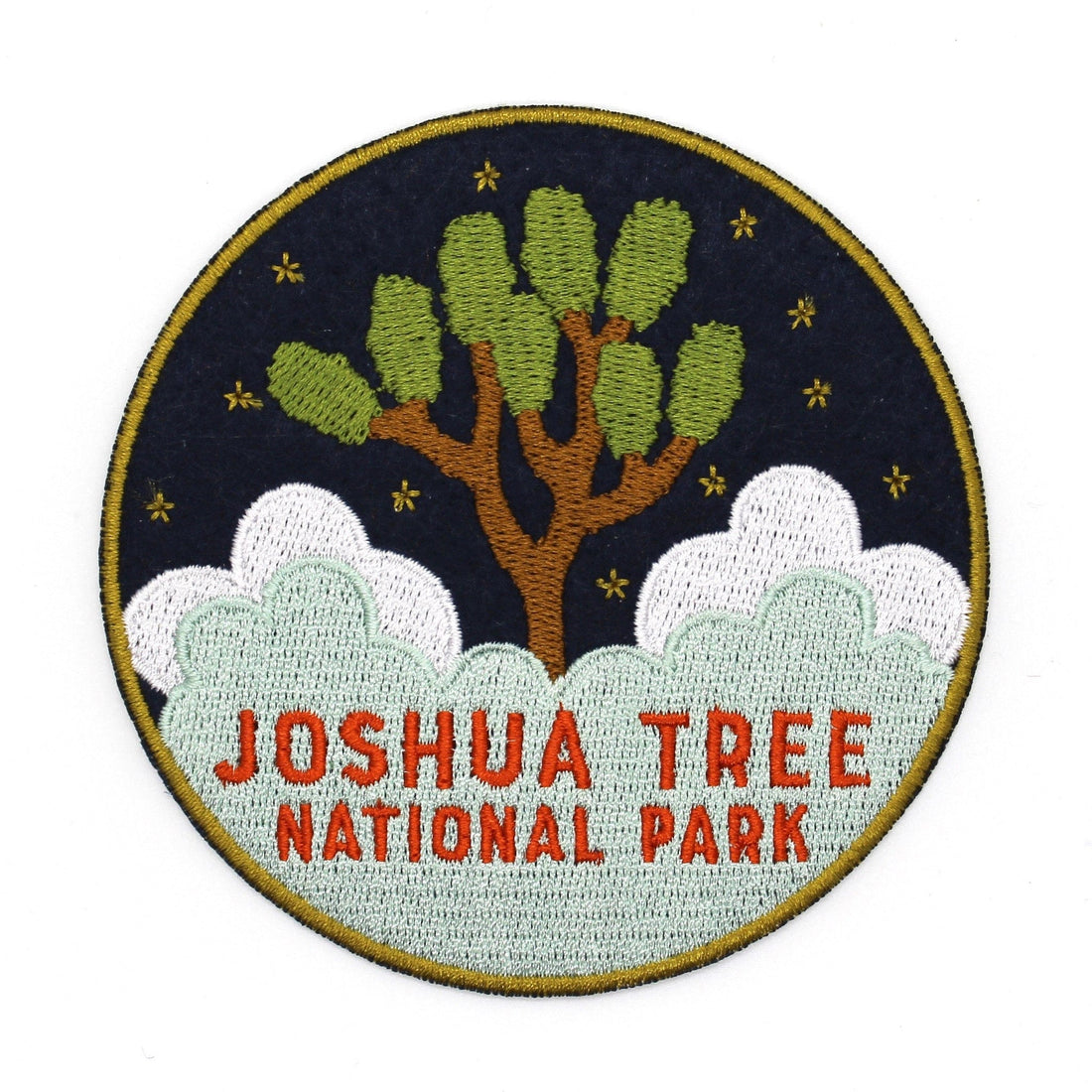 Joshua Tree National Park souvenir patch with clouds and Joshua Tree embroidered on navy blue felt. 
