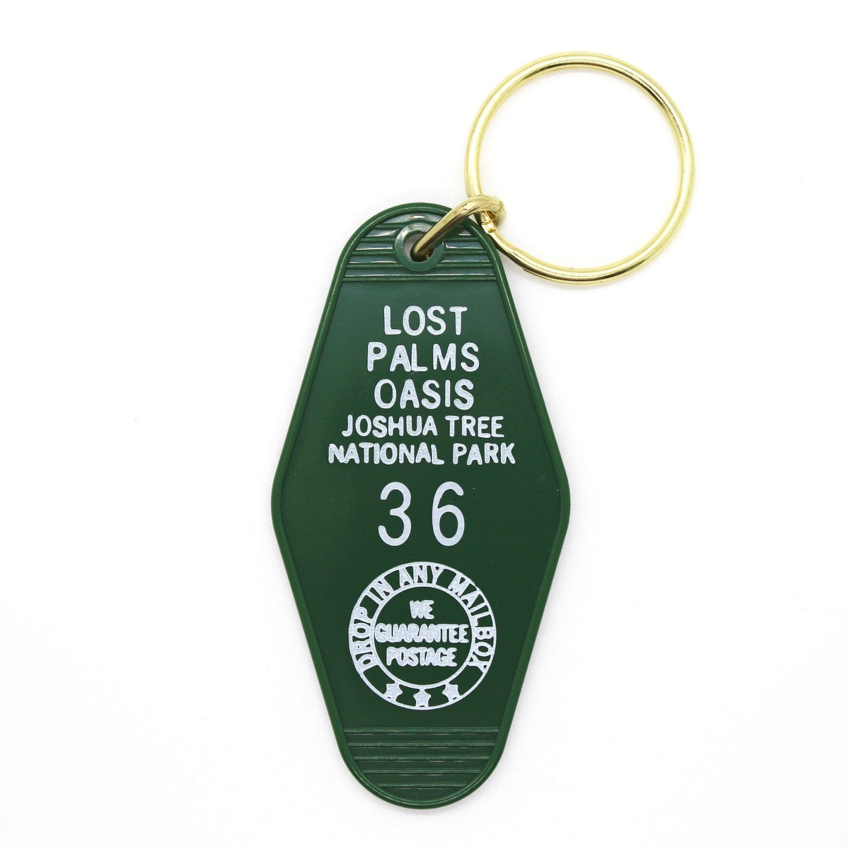 A green motel-style keychain with the inscription 'LOST PALMS OASIS JOSHUA TREE NATIONAL PARK' and the number '36' stamped on the tag.
